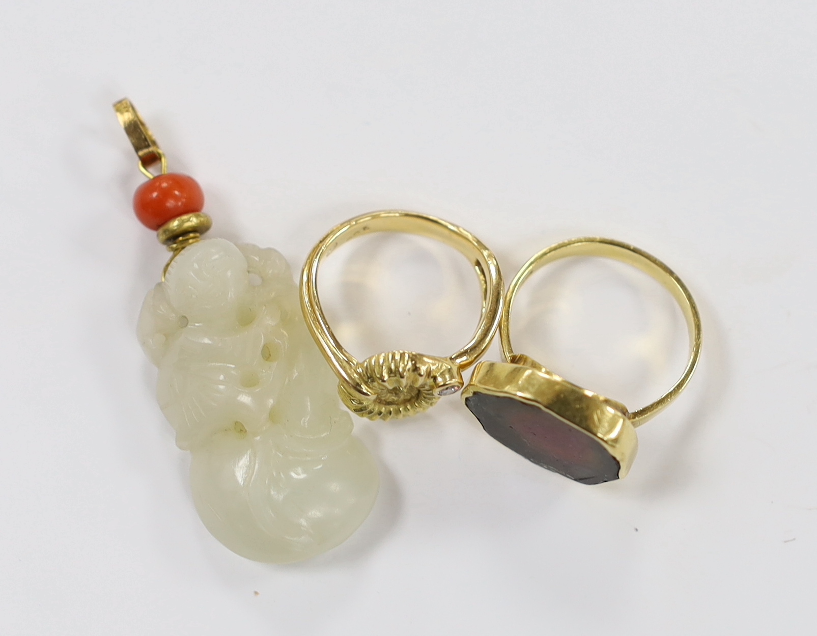 A yellow metal and coral bead mounted carved jade pendant, overall 49mm, a 1970's 18ct gold and tourmaline? set modernist ring, maker, GR and a 750 yellow metal and diamond set urchin ring, maker LH, gross weight 13.5 gr